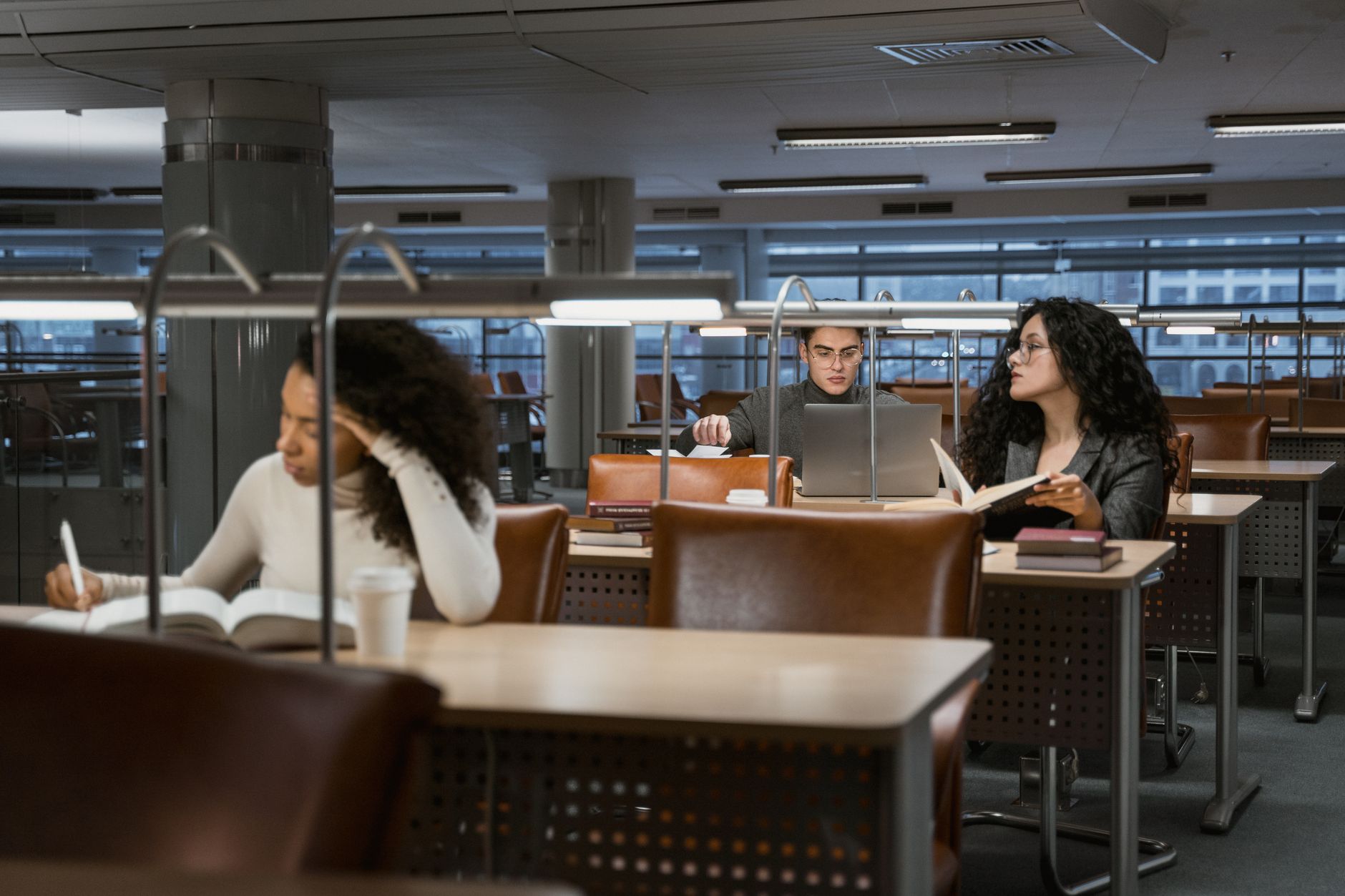 Students reviewing study documents together in a library